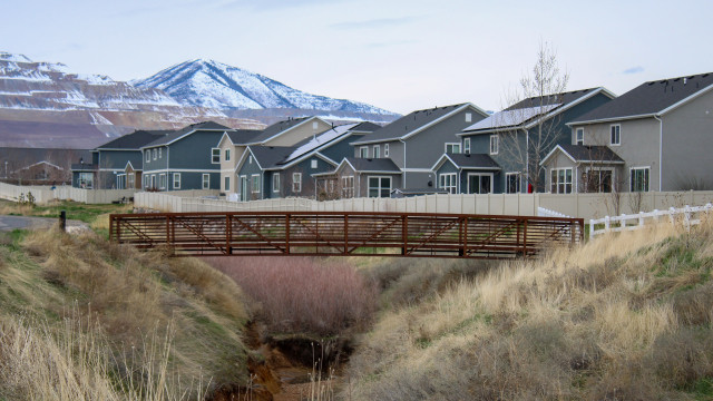 neighborhood with bridge and mountains in background